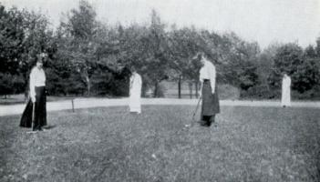 Students playing croquet