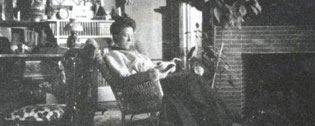 Female in a rocking chair reading c. 1900-1910 