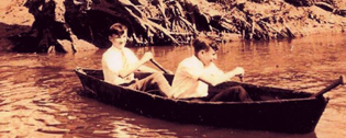 Image of two teens rowing a boat